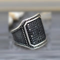 Black alloy fashion ring with a central zircon stone and copper metal inlays on a dark band.
