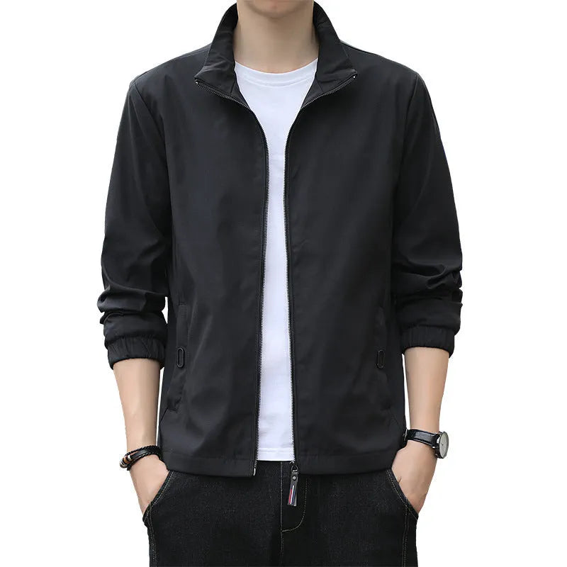 Man wearing a loose-fit grey lapel jacket, a Korean-style autumn casual outerwear piece with zipper pockets.