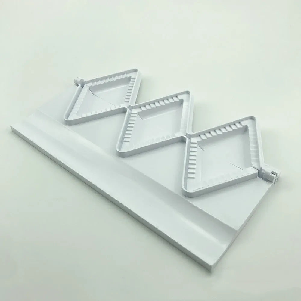 White plastic dumpling mold 28.5cm long on plain background