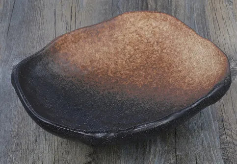 Japanese-style irregular coarse pottery sashimi bowl with floral decoration on glaze