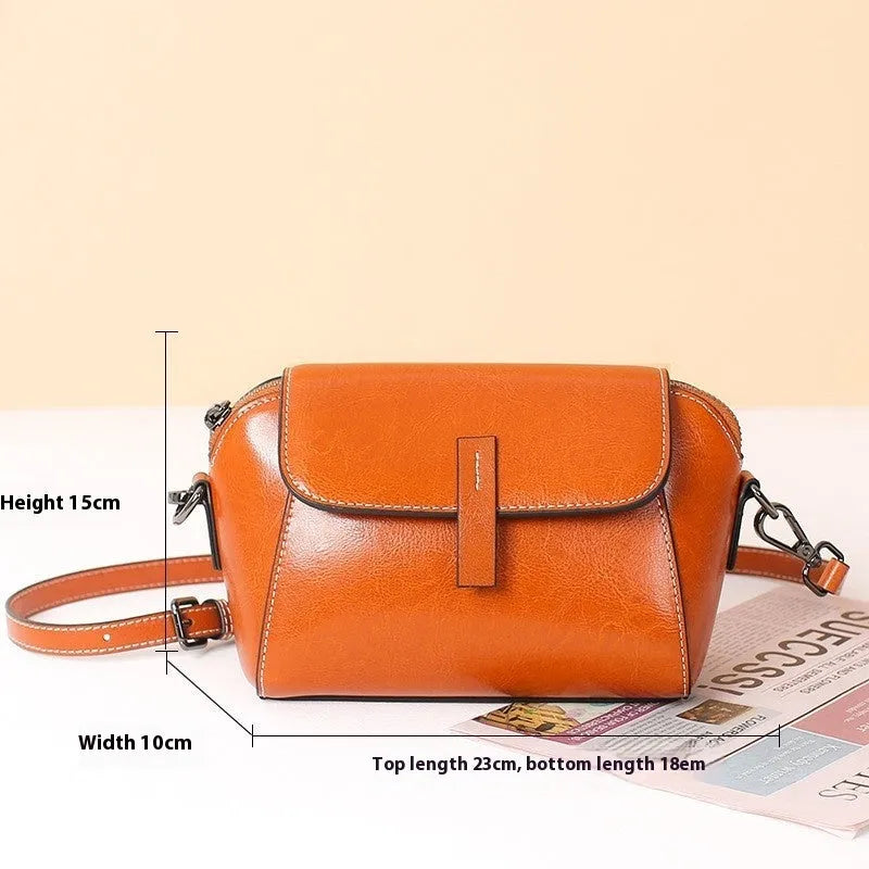 Women's brown oil wax leather messenger bag with crossbody strap and shell shape design