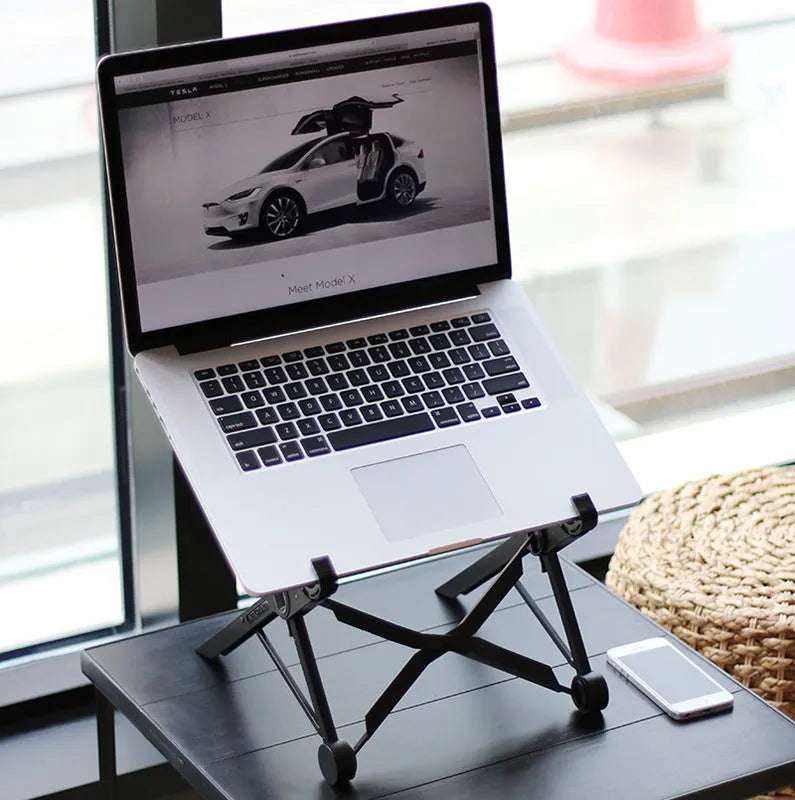 Black foldable enhanced nylon laptop stand shown open next to its portable carry bag.