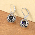 Silver tone geometric earrings with hollow pendant designs and blue gemstone accents