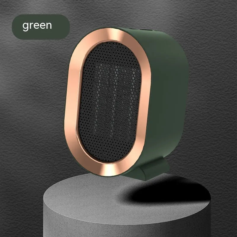 Compact desktop ceramic fan heater in black on a wooden desk.