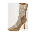 Gold coloured pointed toe stiletto high heel sandals with a mesh upper.