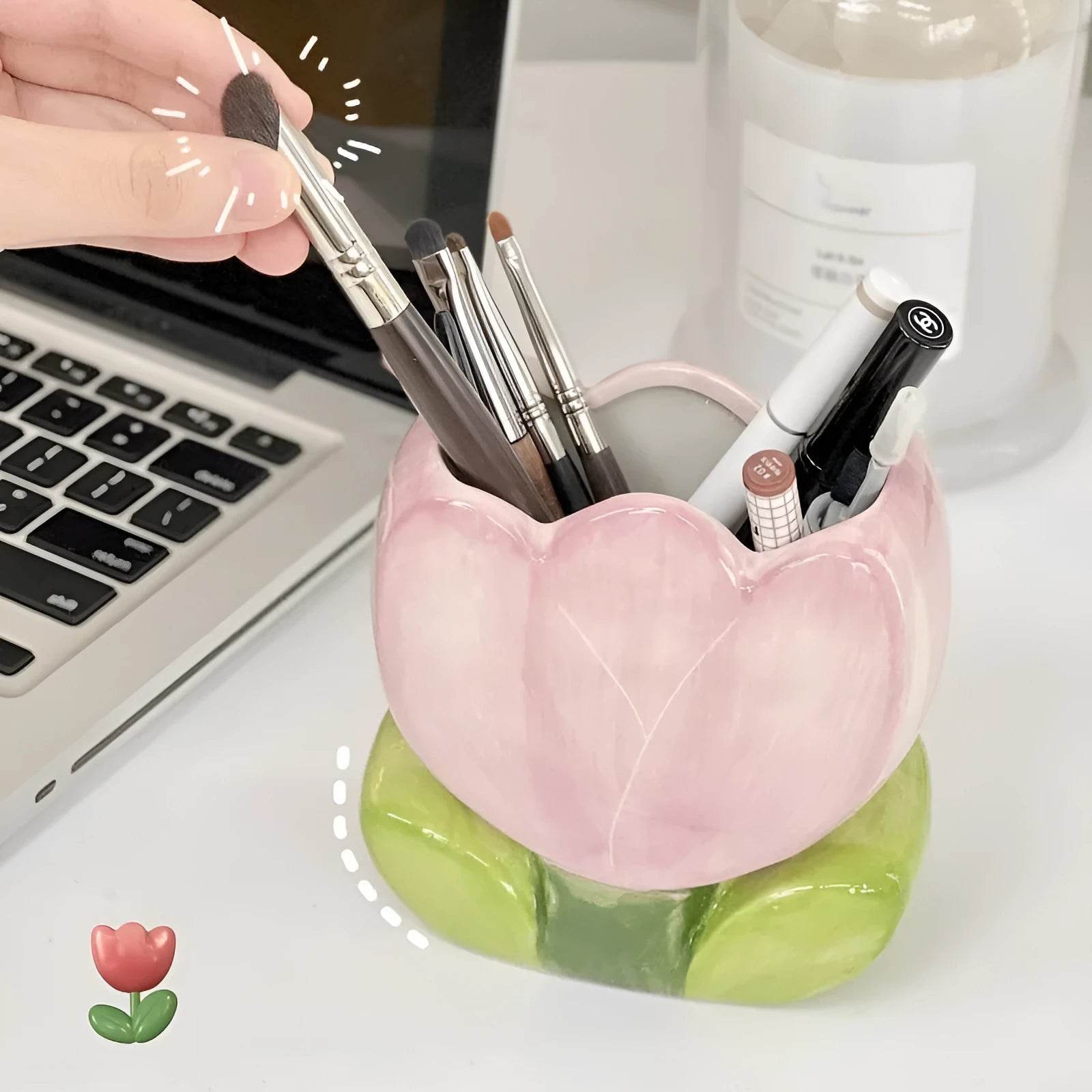 Ceramic floral pen holder box in pink tulip design on a desk.