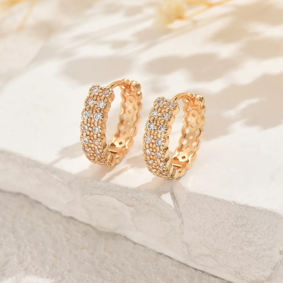 A pair of women's copper geometric ear studs with a dot and ring design, shown against a plain background.