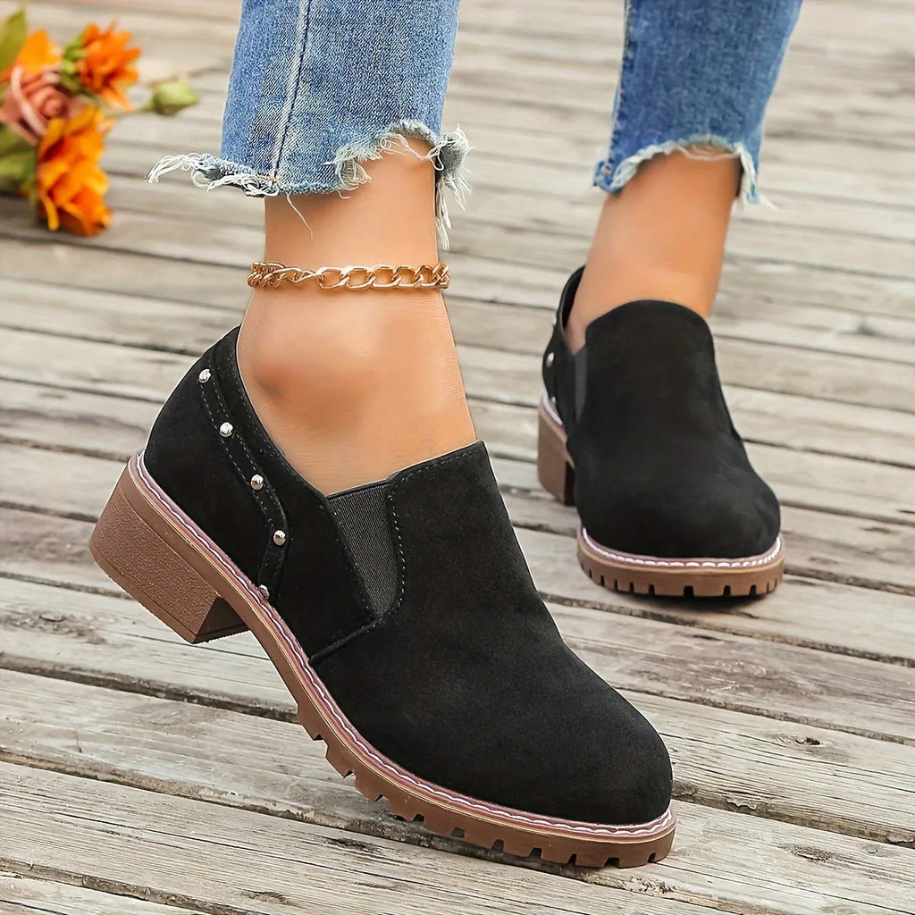 Women's light brown suede ankle boots with a low block heel and elasticated ankle cuff.