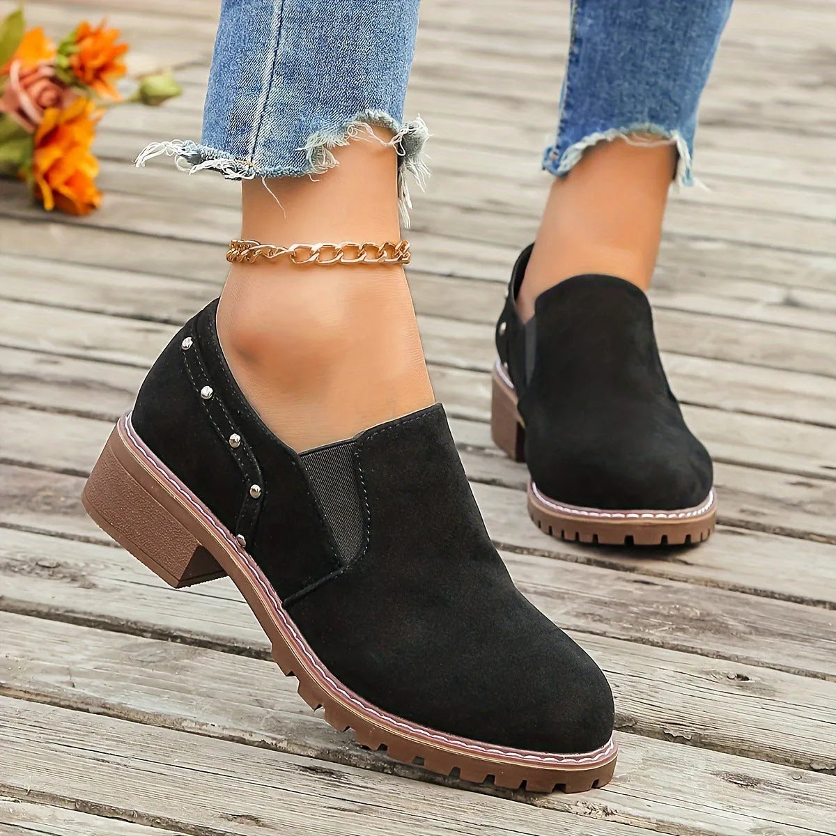 Women's light brown suede ankle boots with a low block heel and elasticated ankle cuff.