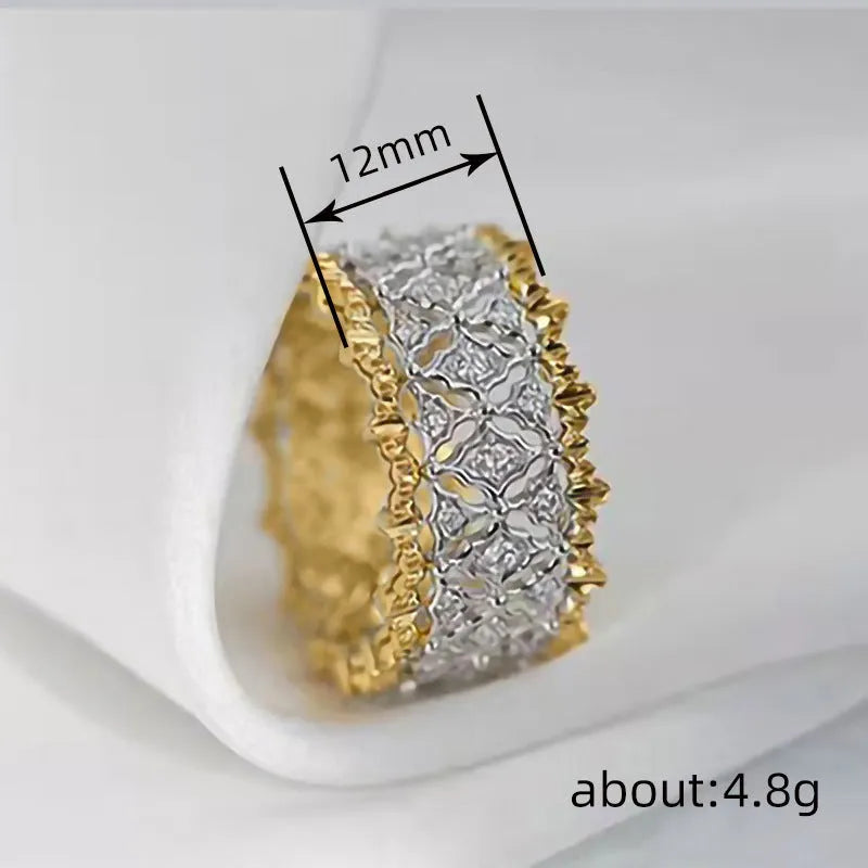 Geometric two-tone gold zircon ring with round centrepiece on a copper band.