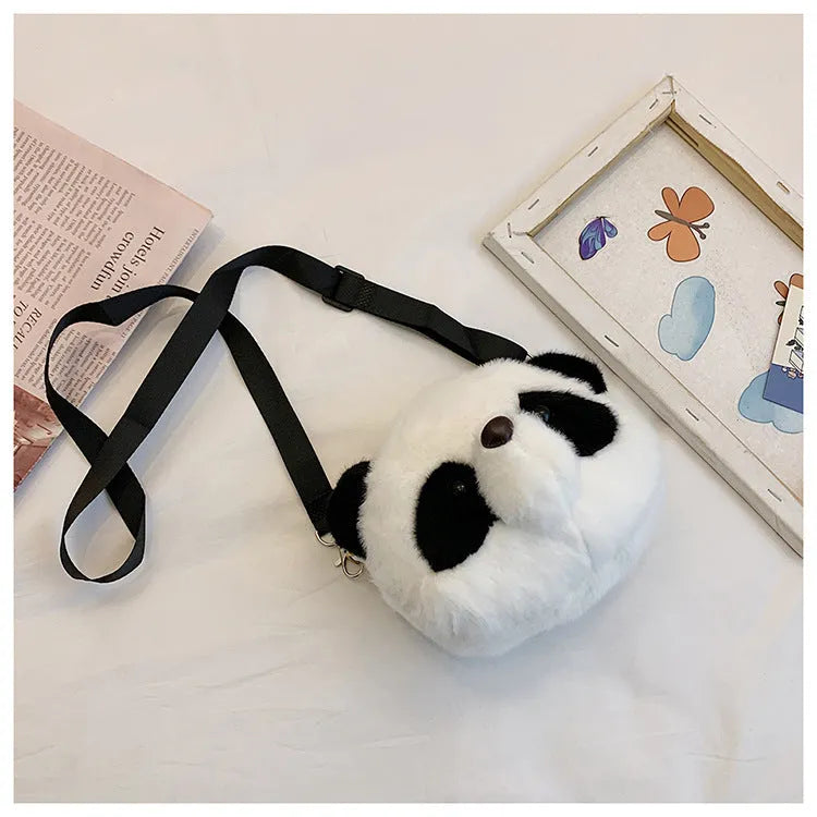Soft plush crossbody bag in panda head colour with cylindrical shape and sandwich pocket.