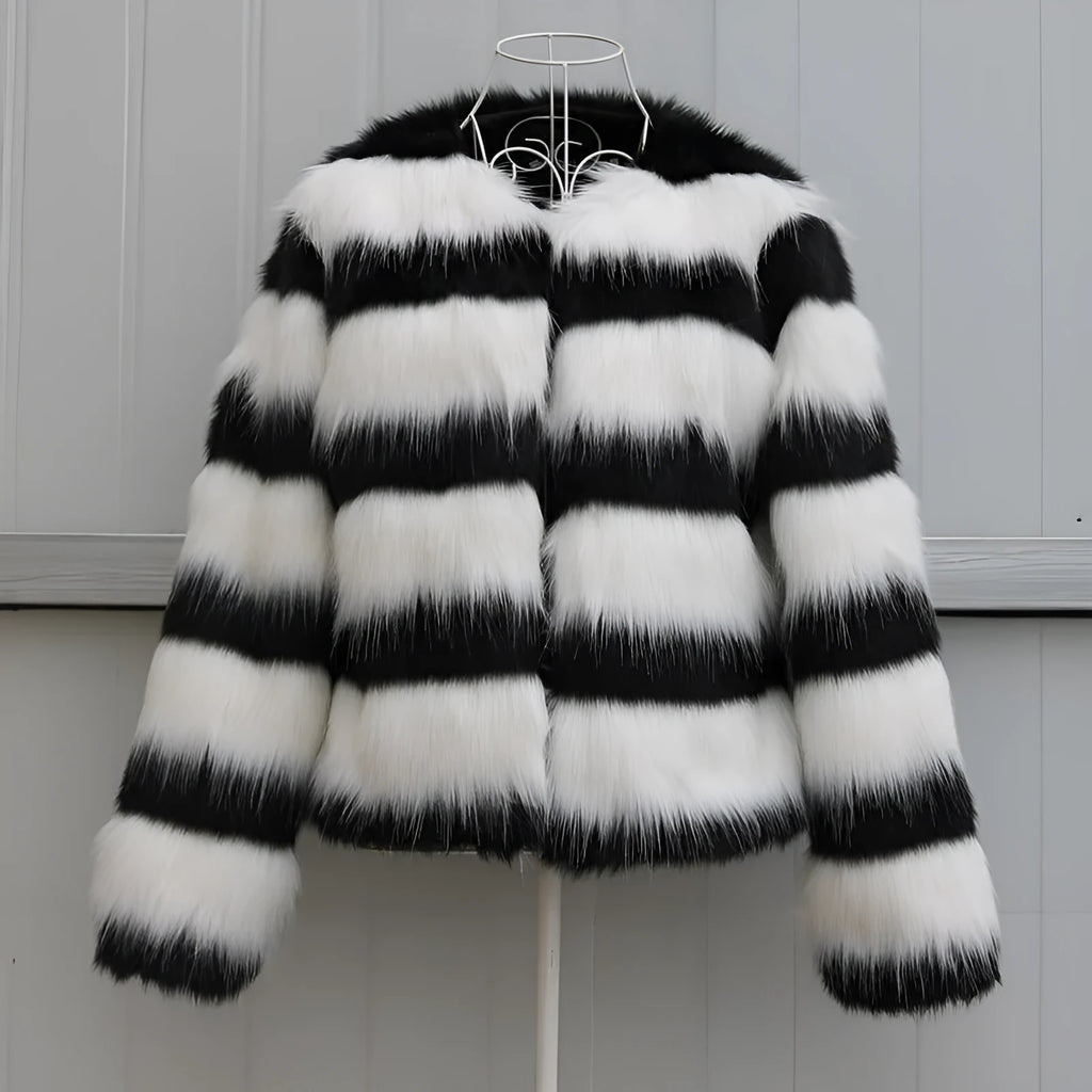 Womens black and white striped faux fur leather jacket with long sleeves on a model.