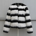 Womens black and white striped faux fur leather jacket with long sleeves on a model.