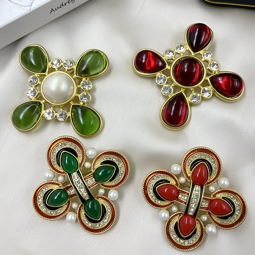 Close-up of a vintage medieval baroque style zinc alloy brooch with a crystal cross centrepiece.