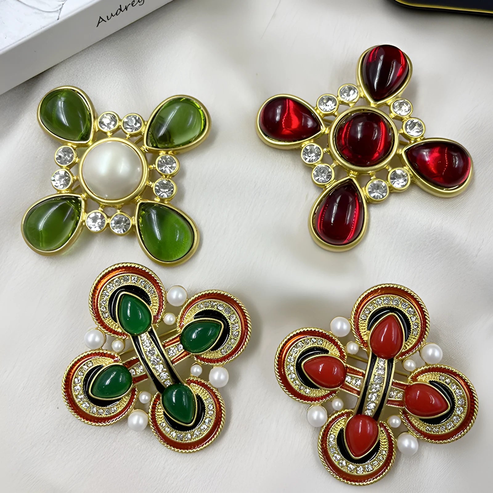 Close-up of a vintage medieval baroque style zinc alloy brooch with a crystal cross centrepiece.