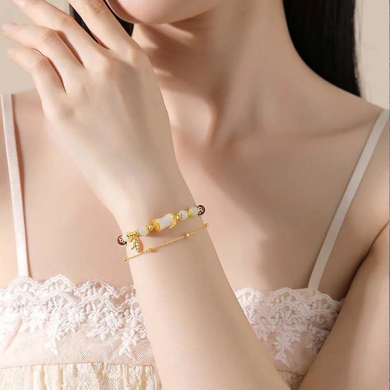 Bamboo-themed bracelet with a coloured glass flower and ruyi pattern in beige, green, light green, or white.