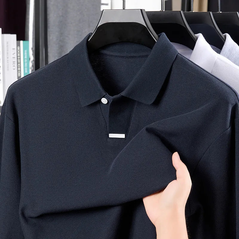 Men's grey cotton polo shirt with a lapel collar and long sleeves on a hanger.