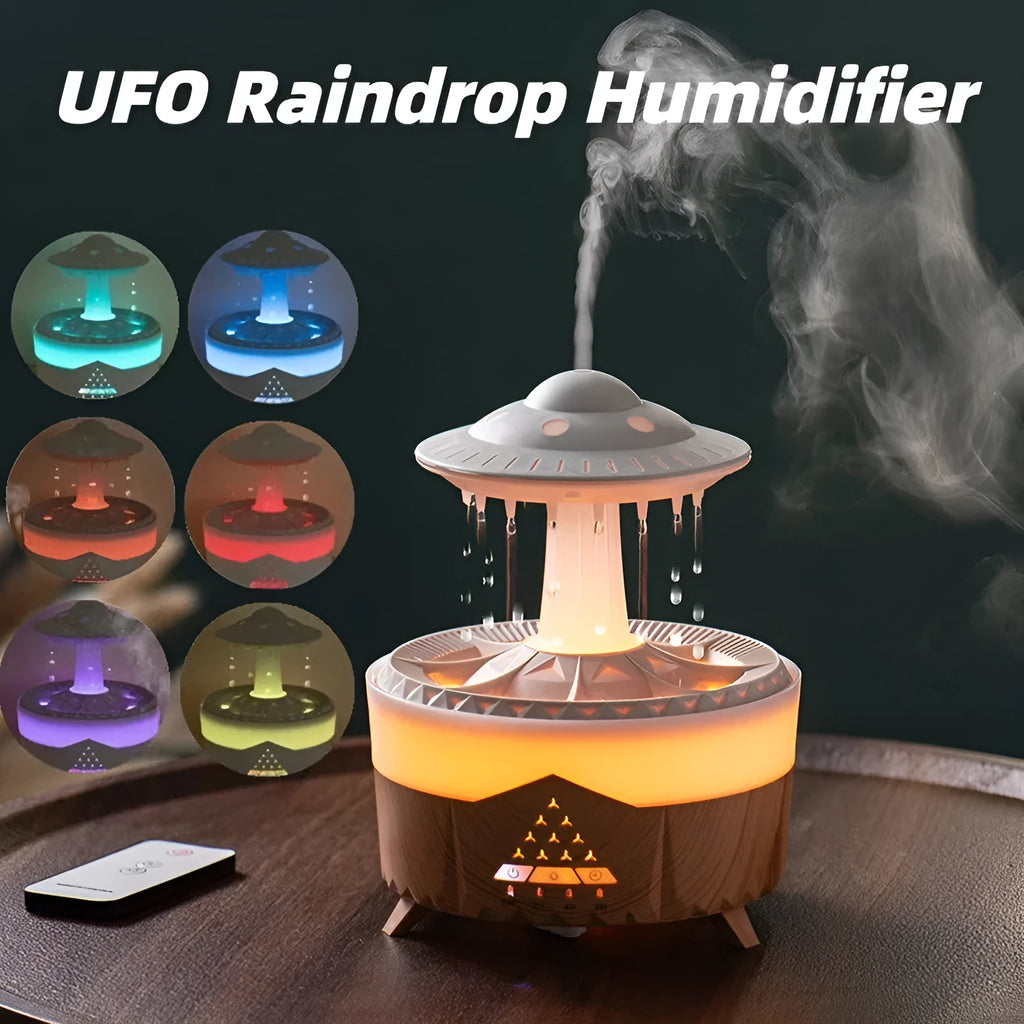 White UFO-shaped cloud humidifier with mist and soft blue night light on a wooden table