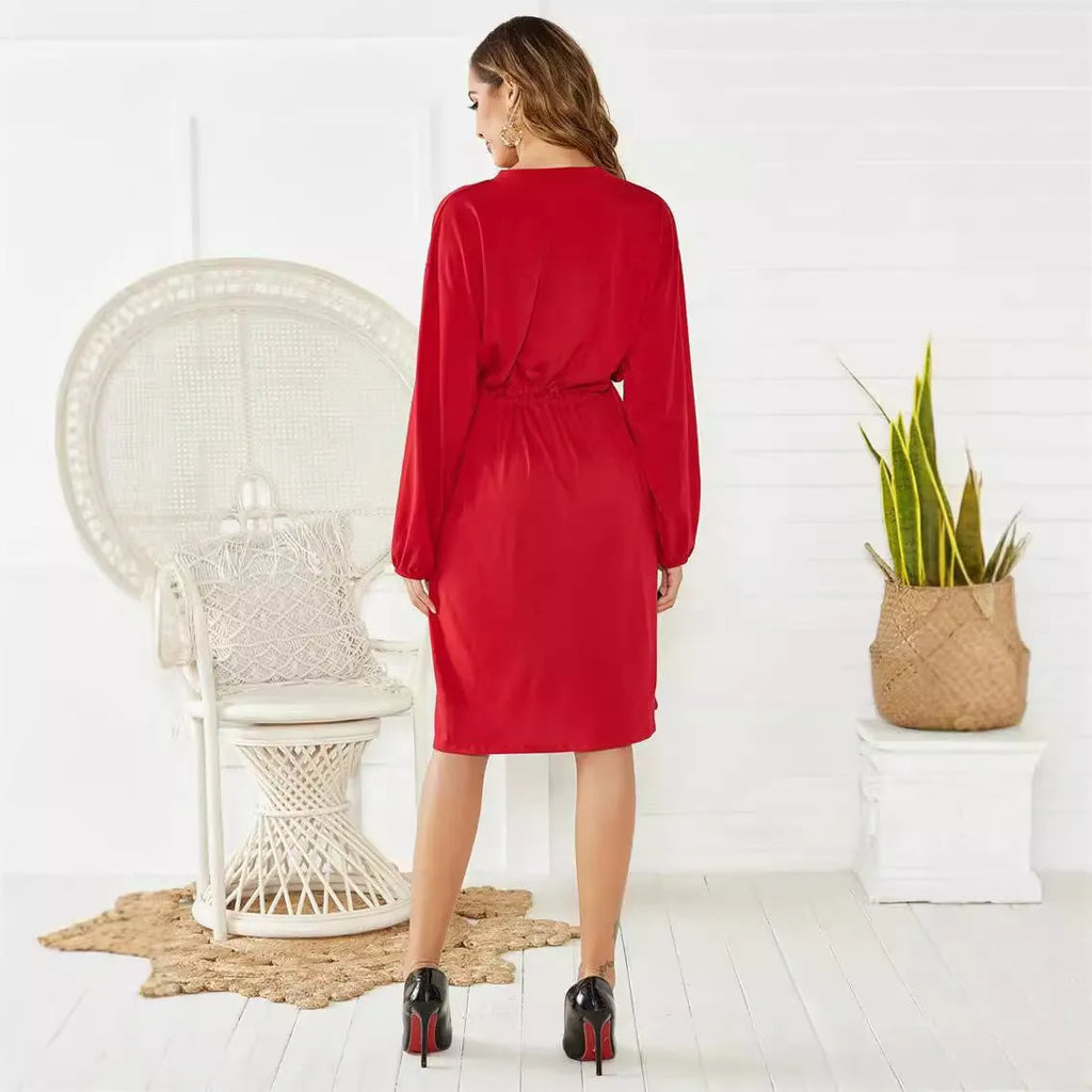 Black mid-length A-line dress with long sleeves, elasticated waist, and a detachable red belt.