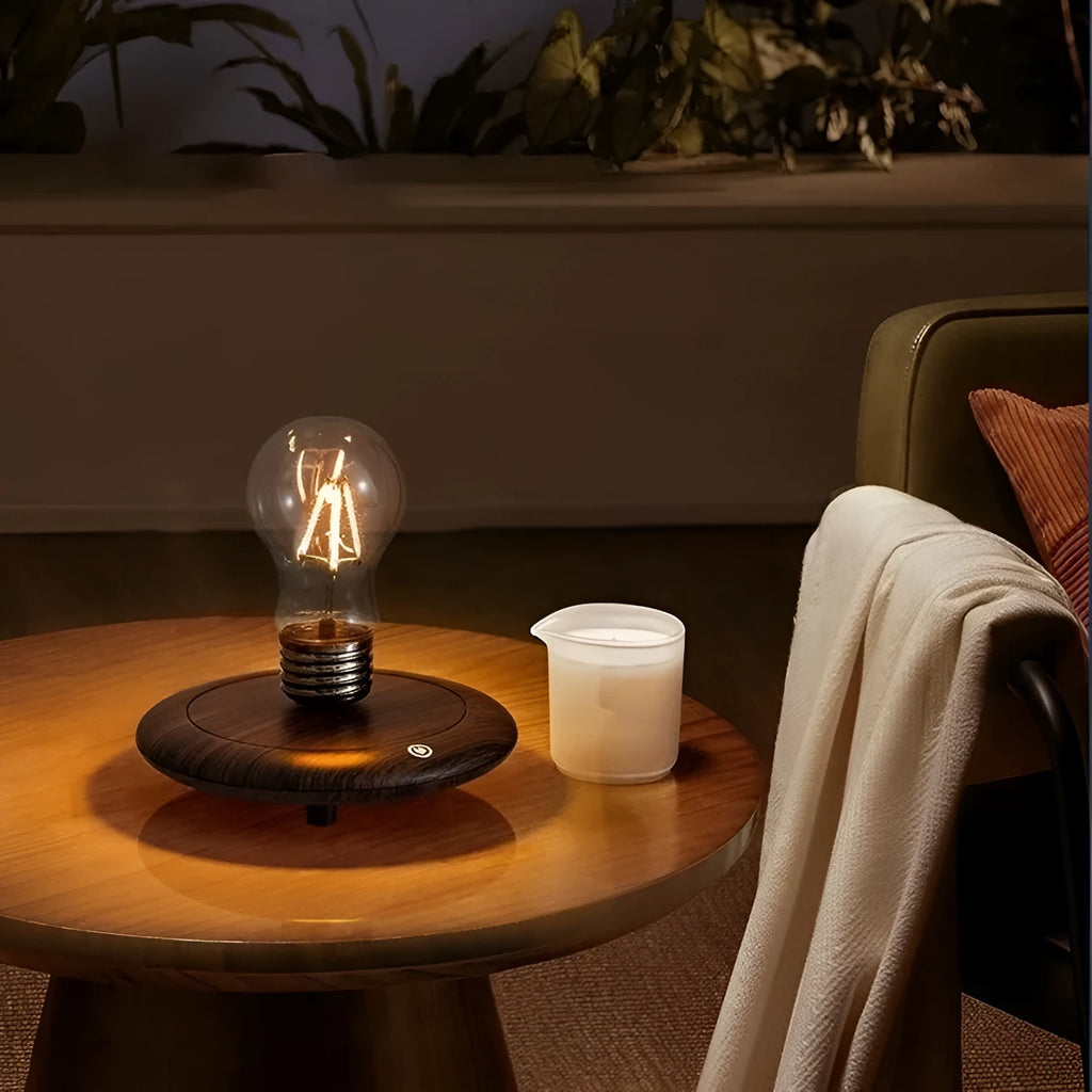 Small black suspension bulb desk lamp with iron art body on a wood grain base.