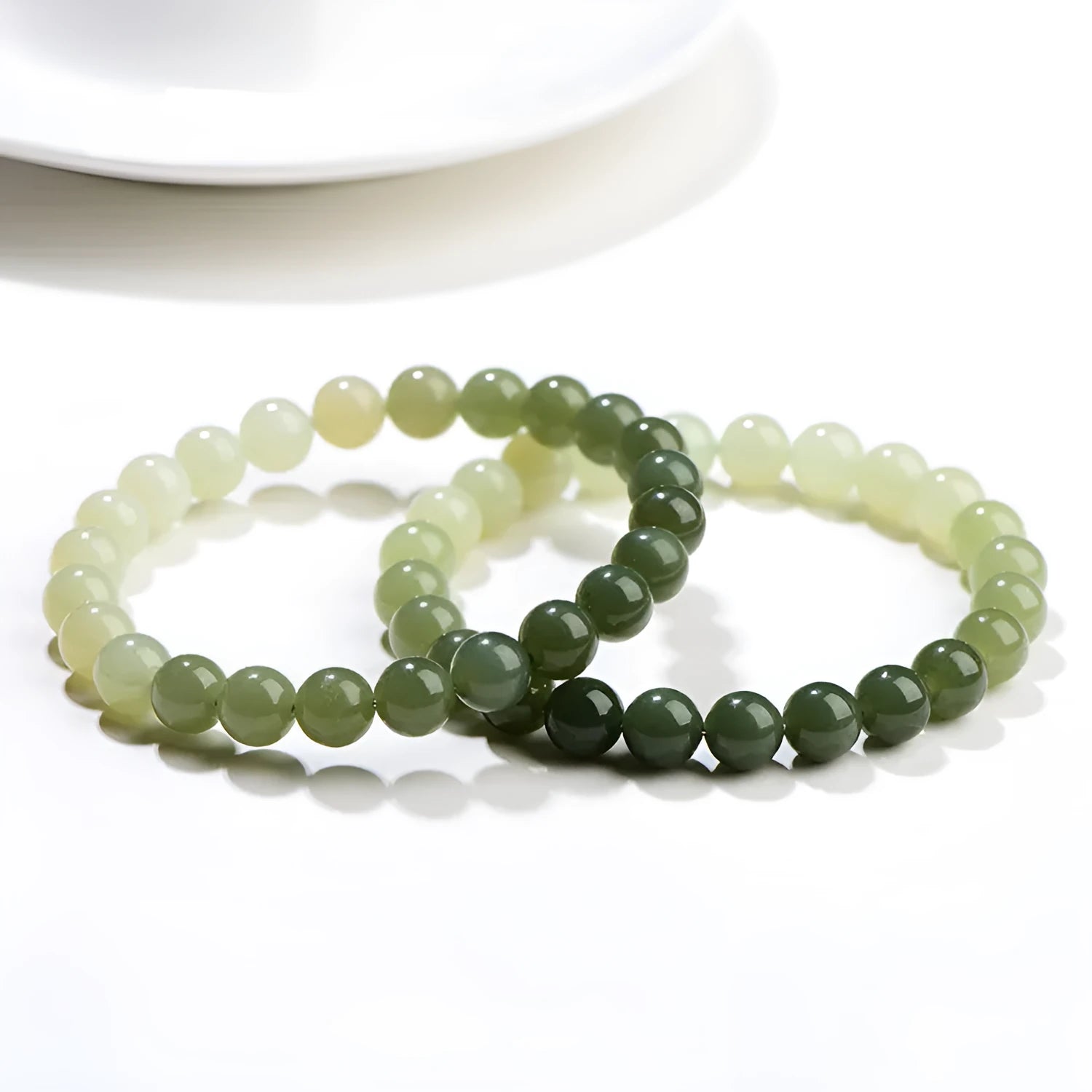 Natural clear water Hetian jade ball bracelet with round beads on a wrist.