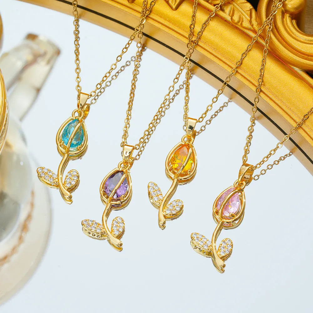 Gold tulip pendant necklace with zircon stones on an adjustable O-ring chain, showing colour options.