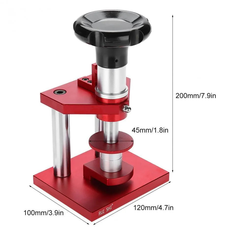 Watch back cover press tool, a spiral cap presser machine, shown with a set of 20 plastic moulds for different watch sizes.