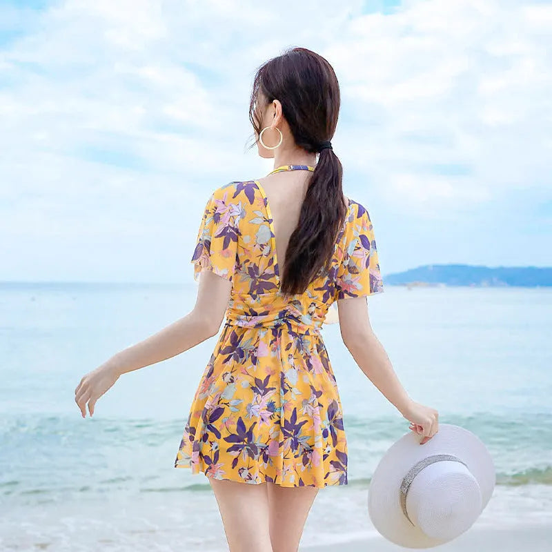 Yellow floral pattern women's one-piece polyester swimsuit on mannequin