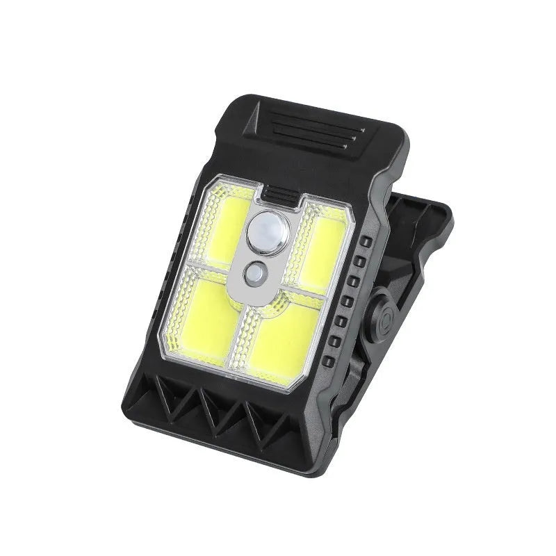 White intelligent motion sensor clip lamp mounted on a shelf edge.
