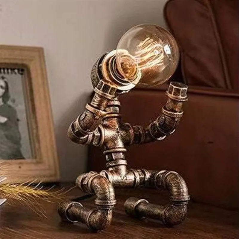 Industrial retro style water pipe robot table lamp made of iron in a vintage colour.