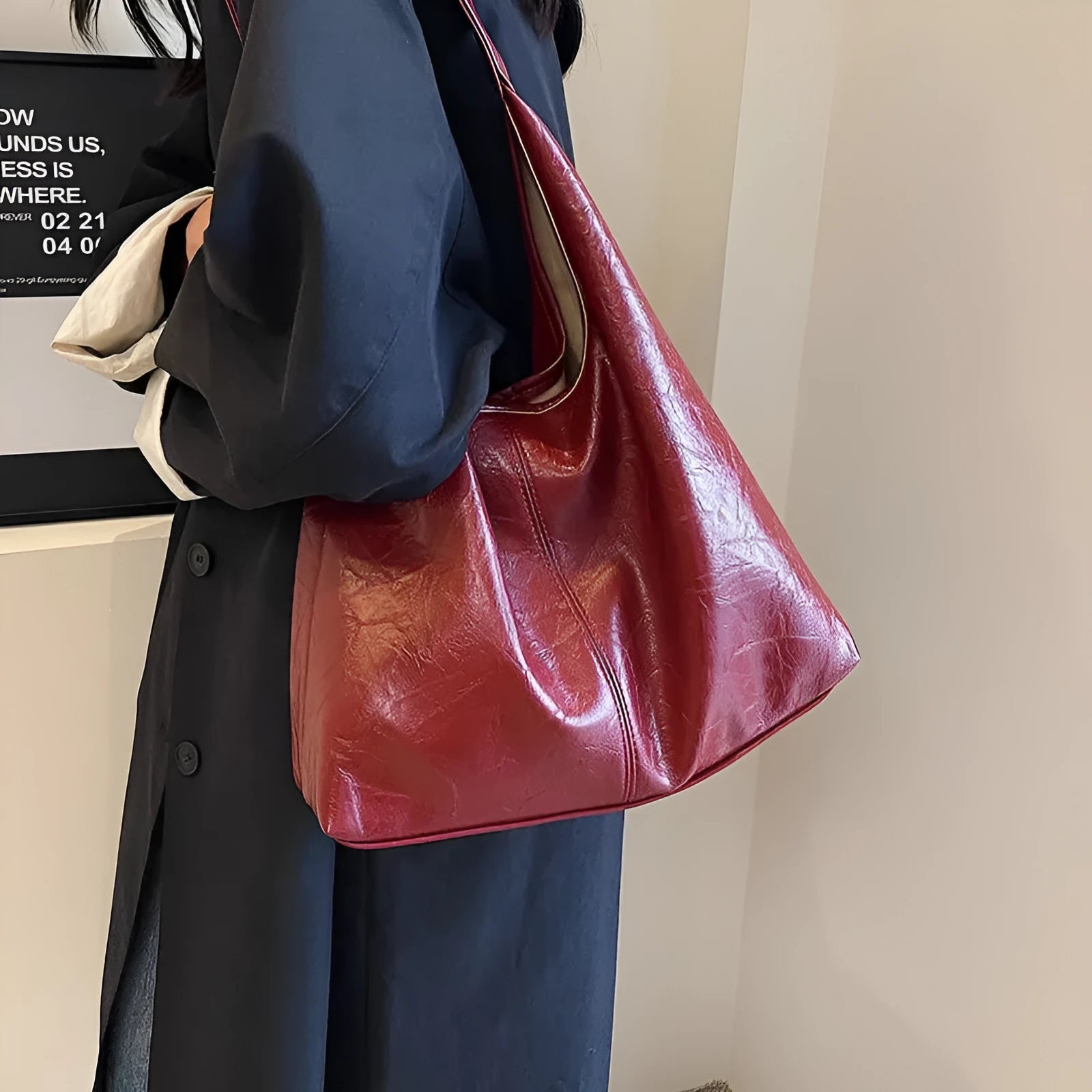 Soft black PU leather women's shoulder bag with large capacity and visible sewing thread detail.