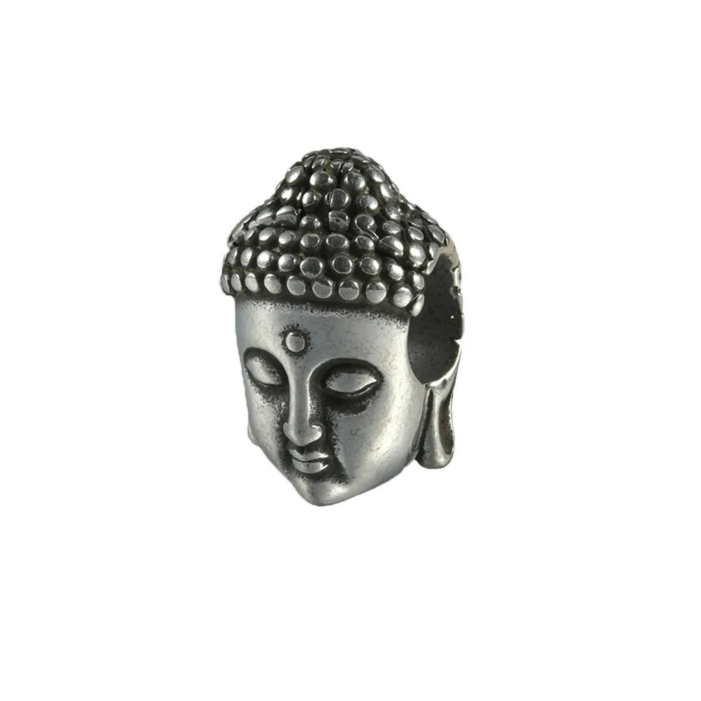 Close-up of a stainless steel hollow skull earring with an electroplated finish, shown alongside a Buddha head design option.