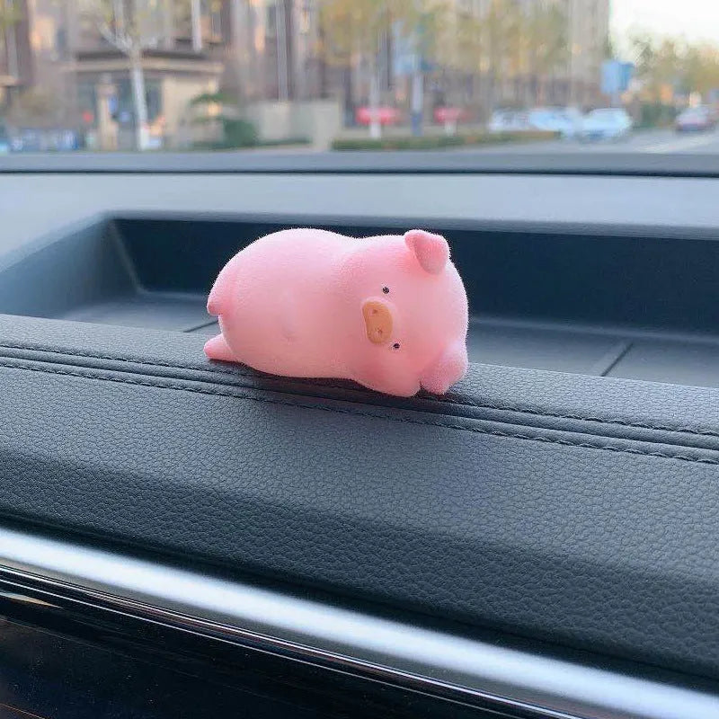 Cute cartoon pig resin figurine car dashboard ornament in one of eight available styles.