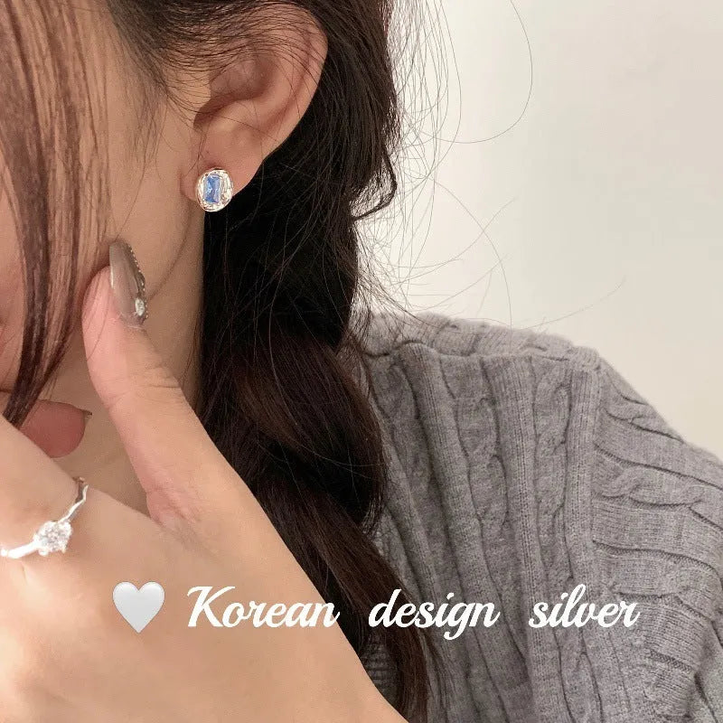 S925 sterling silver oval blue diamond heart-wrapped geometric earrings with electroplated silver finish
