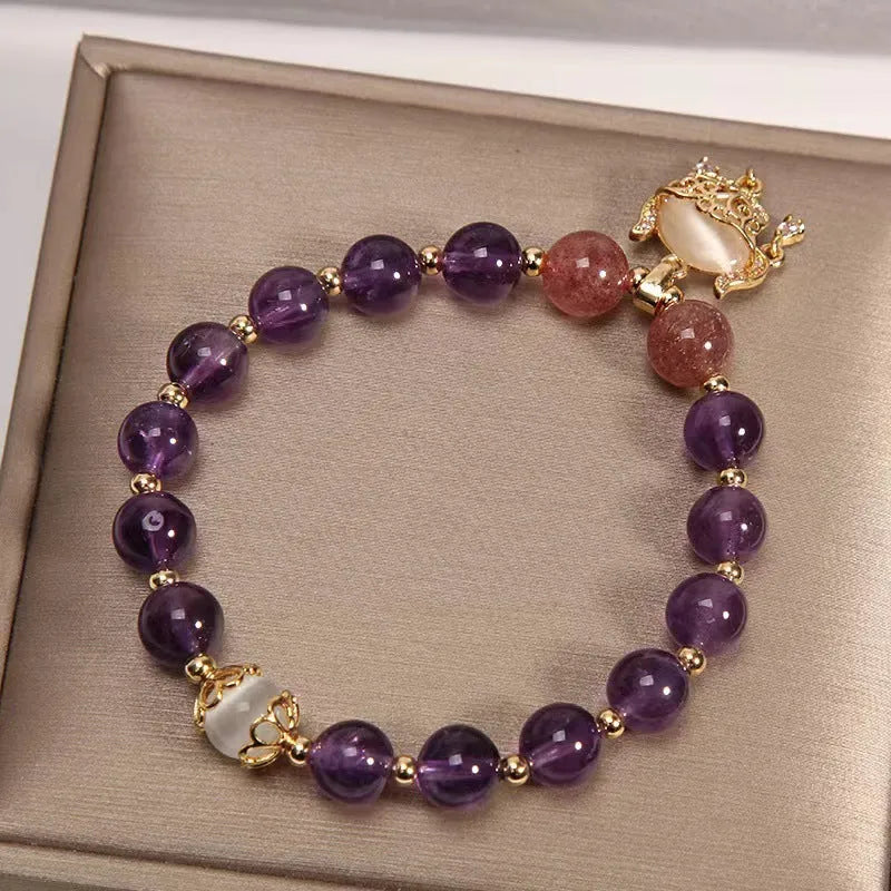 Handmade copper women's bracelet with a drop-shaped real gold longevity lock charm and natural amethyst accents.