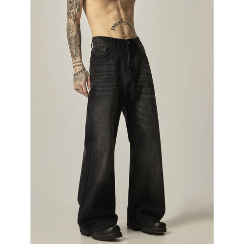 A pair of black loose-fit straight-leg jeans with a retro style on a white background.