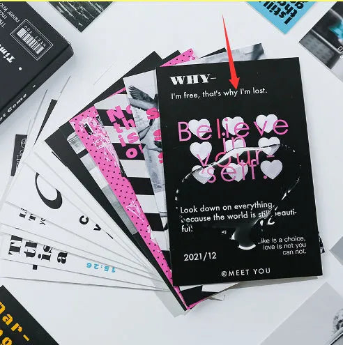 Box of fresh printed postcards showing two creative greeting card designs.