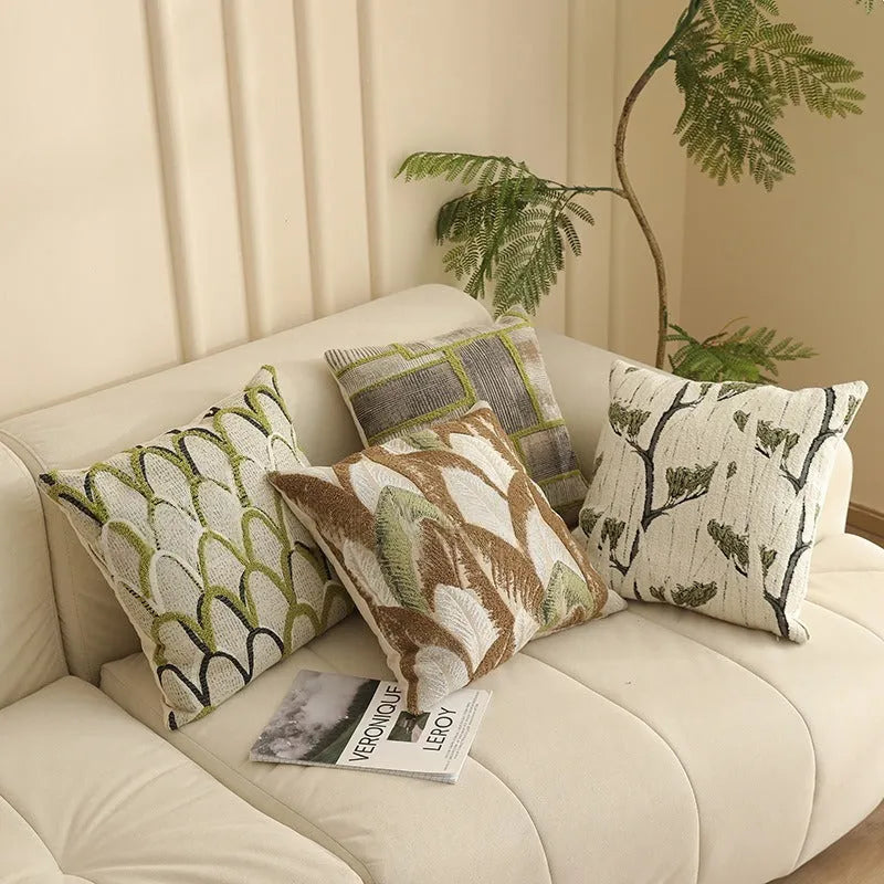 Square 45cm jacquard cushion cover with retro floral pattern in Nordic style on a grey sofa.