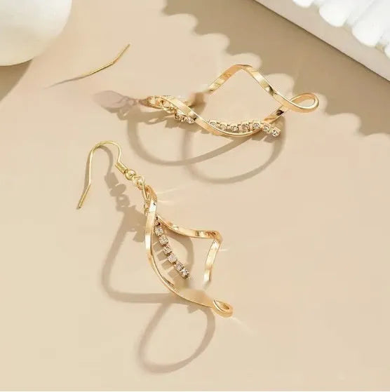 Women's gold alloy earrings with creative spiral design featuring geometric shapes and elliptical elements