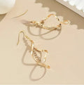 Women's gold alloy earrings with creative spiral design featuring geometric shapes and elliptical elements