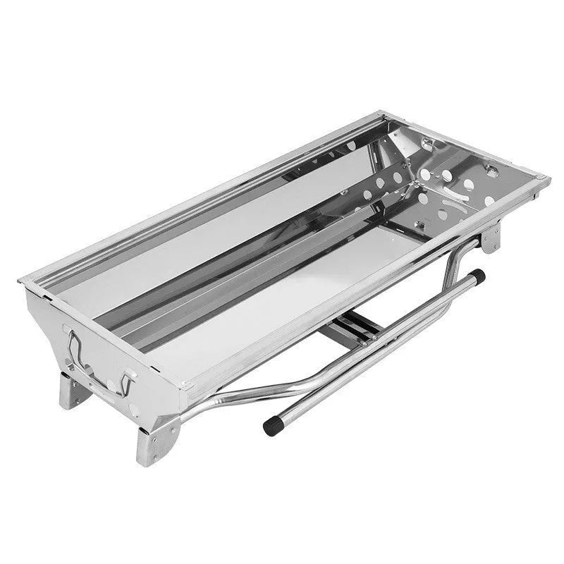 Large stainless steel folding portable barbecue grill set up outdoors.
