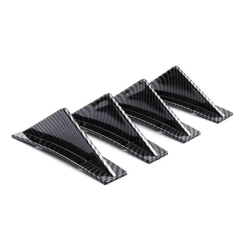 Black triangular car rear spoiler on a white background, shown with screws and adhesive tape.