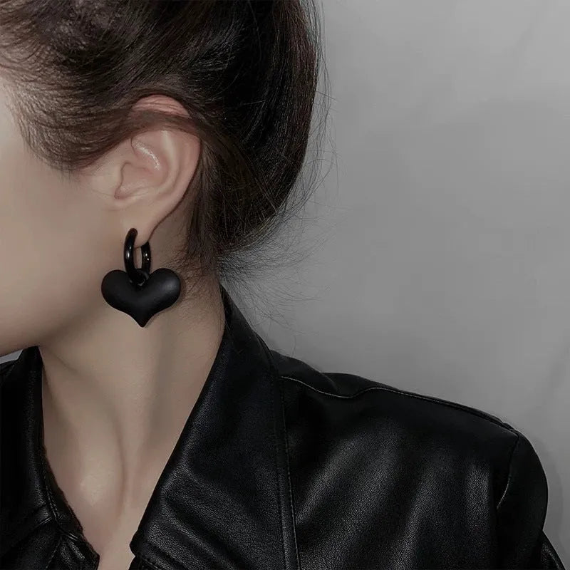 Black heart-shaped earrings with glass inlay in Korean style, shown as one pair