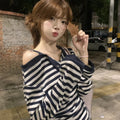 Dark blue women's oversized long-sleeved T-shirt with embroidery and stripes, laid flat.