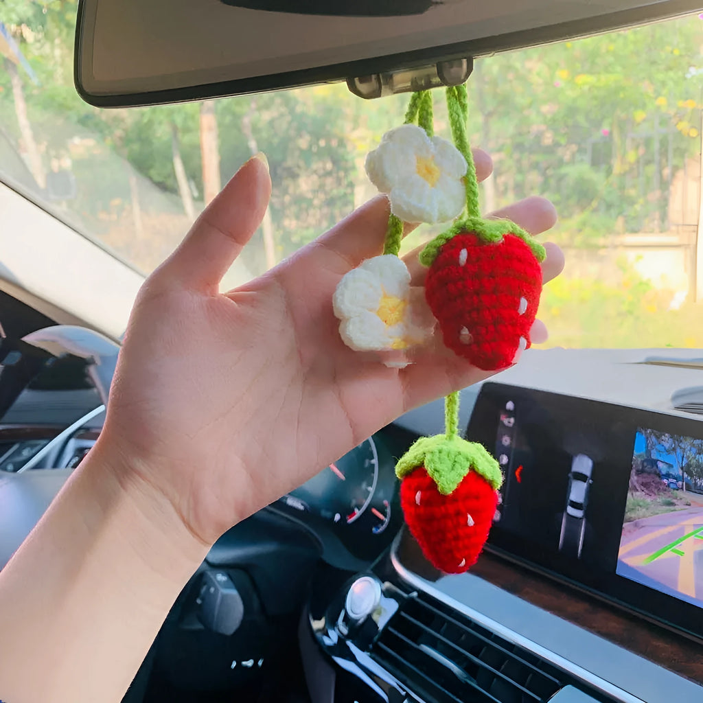 Handwoven strawberry-shaped car pendant made from cotton and hemp fibres.