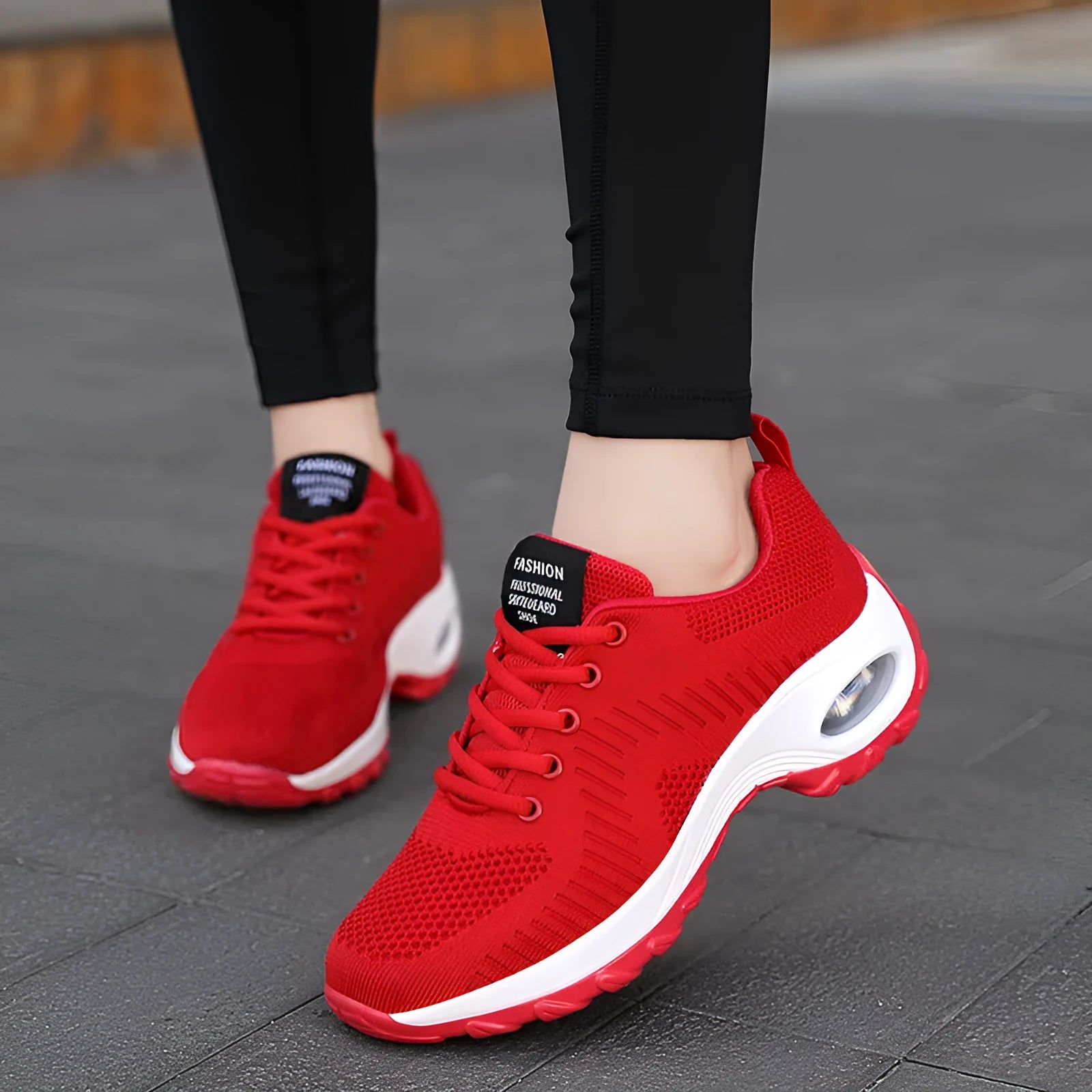Women's red and black round toe lace-up mesh sneakers on a white background, showing the low-top profile and flat PU sole.
