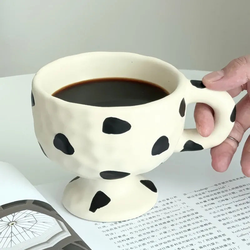 Handmade irregular solid colour ceramic mug on a table