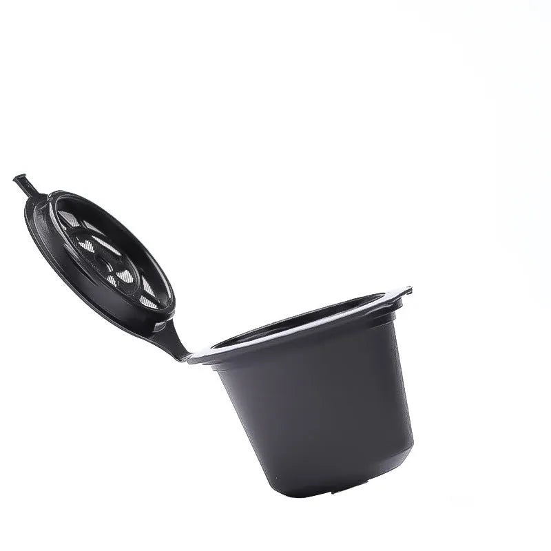 Six plastic coffee filter cups in black, red, and brown with a spoon, reusable shell capsule design for home brewing