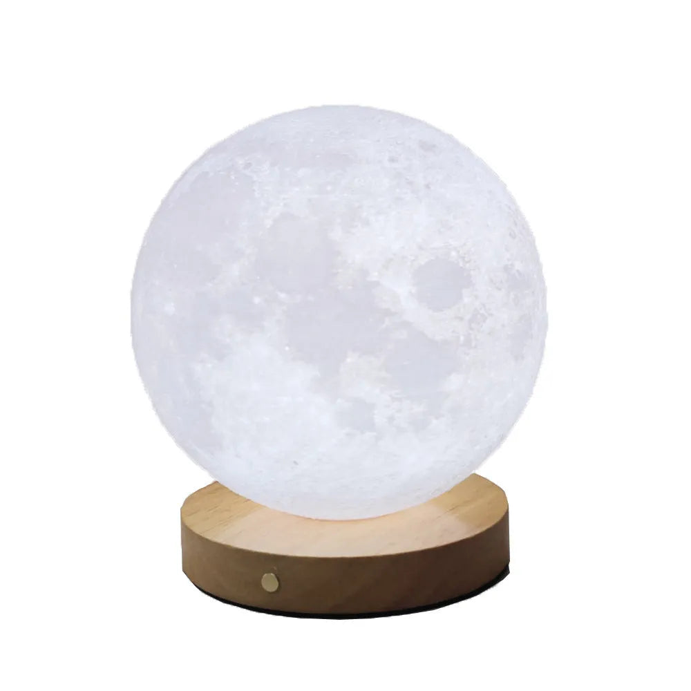 Rotating moon night light on wooden base showing three colour options and size scale