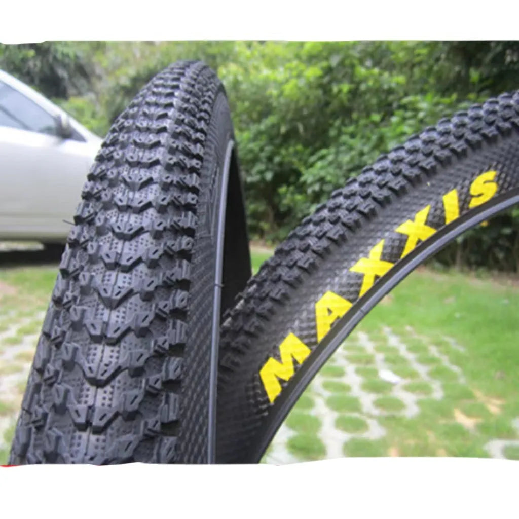 Mountain bike tyre with tread, shown in multiple size options: 26, 27.5 and 29 inch diameters.